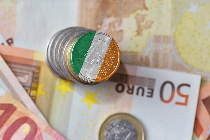 Euro coins and note with Irish flag colours