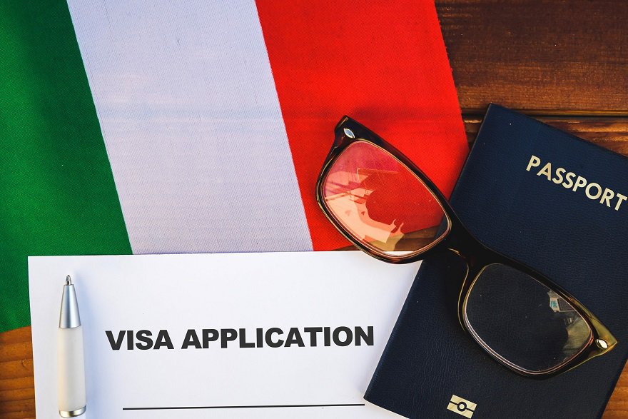 Moving to Italy - Flag of Italy , visa application form and passport on table